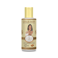 Gold Skin body oil bottle with a woman's face on the label against a white background
